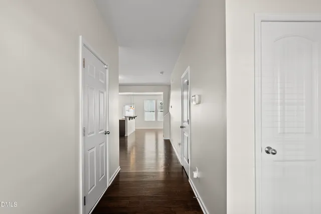 a view of a hallway with a wooden door
