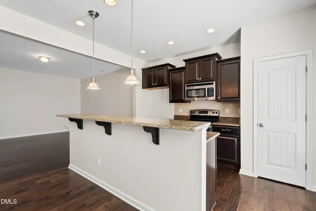 a kitchen with stainless steel appliances a refrigerator sink and microwave