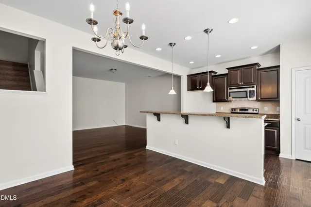 a kitchen with stainless steel appliances kitchen island a refrigerator sink and microwave