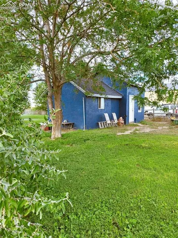a view of a house with a yard and sitting area