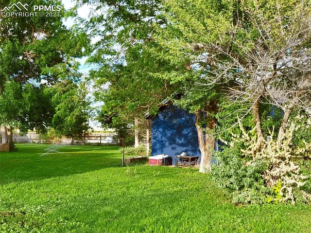 a view of a house with a backyard