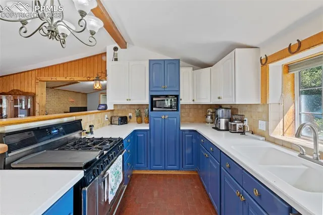 a kitchen with stainless steel appliances granite countertop a stove and a sink