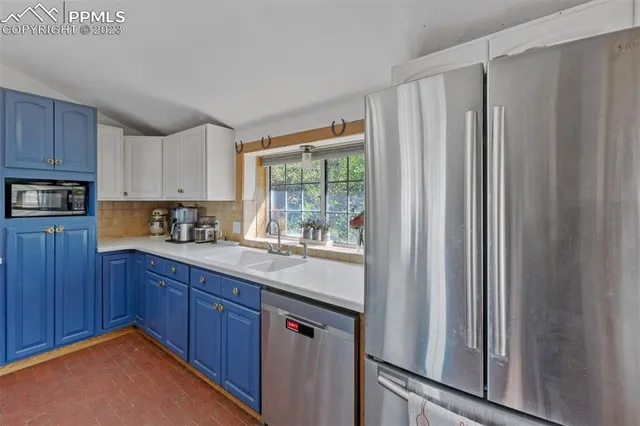 a kitchen with stainless steel appliances granite countertop a refrigerator and a sink