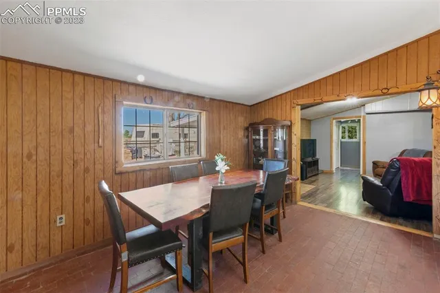 a dining room with furniture and window