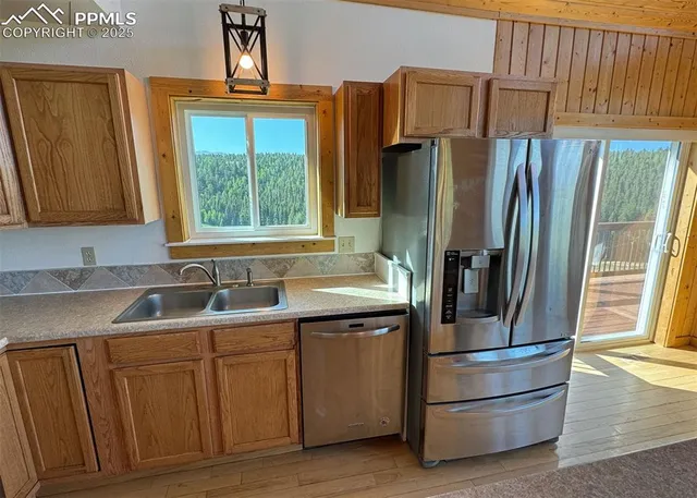 a kitchen with appliances a sink and a window