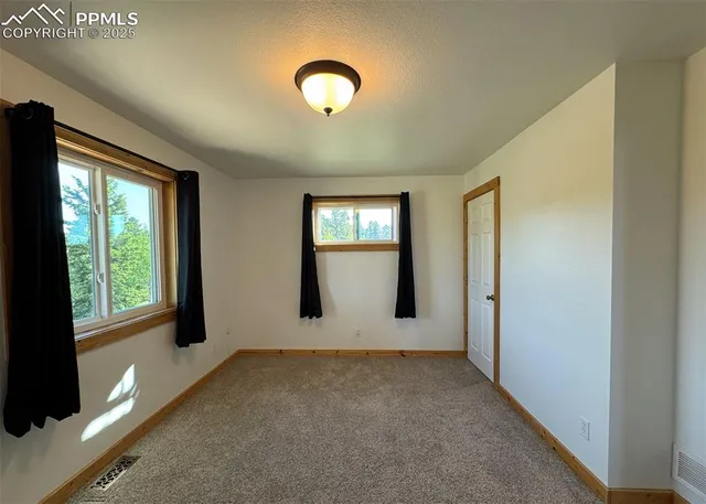 a view of an empty room with windows