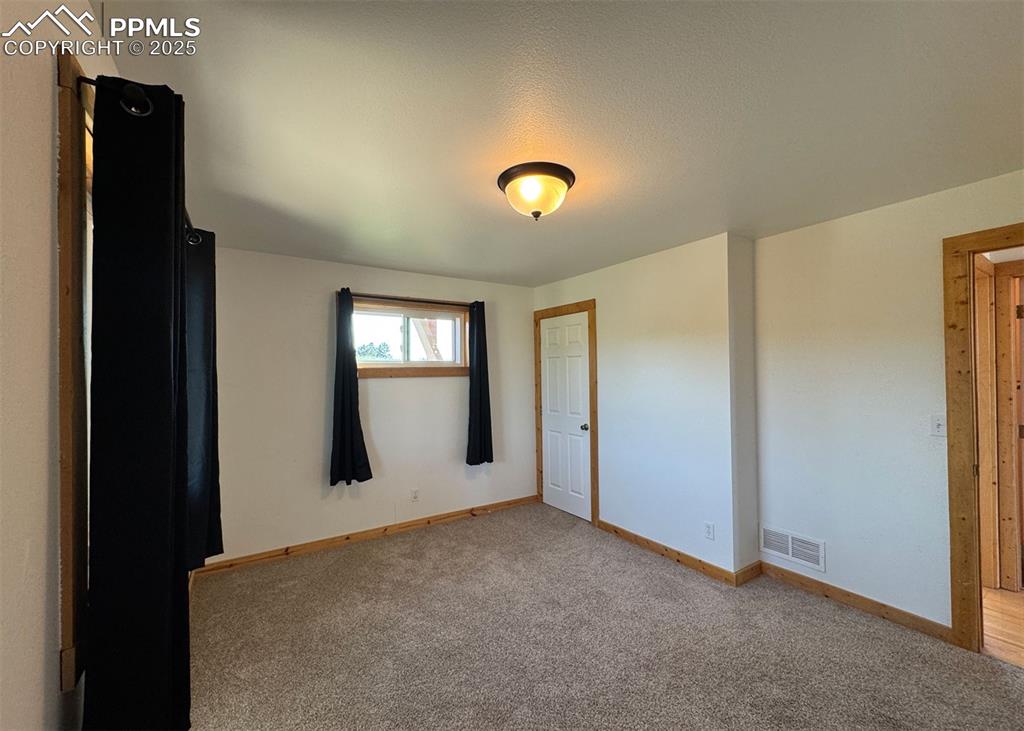 61 Muskrat Lake View Divide, CO 80814 - Photo 27 of 50 a view of an empty room with window and wooden floor