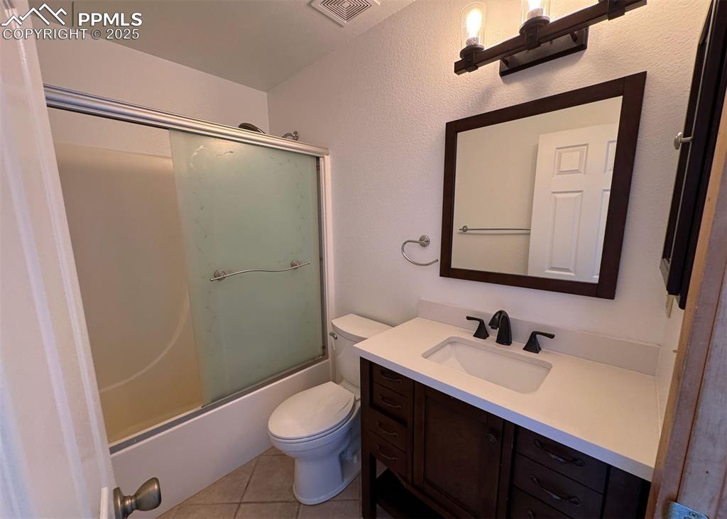 61 Muskrat Lake View Divide, CO 80814 - Photo 28 of 50 a bathroom with a granite countertop sink toilet and shower