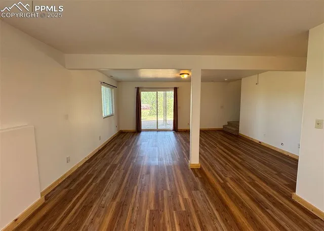 a view of a room with wooden floor
