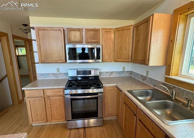 a kitchen with a stove a sink and a microwave