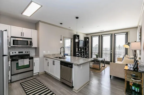 a kitchen with stainless steel appliances granite countertop a stove and a refrigerator