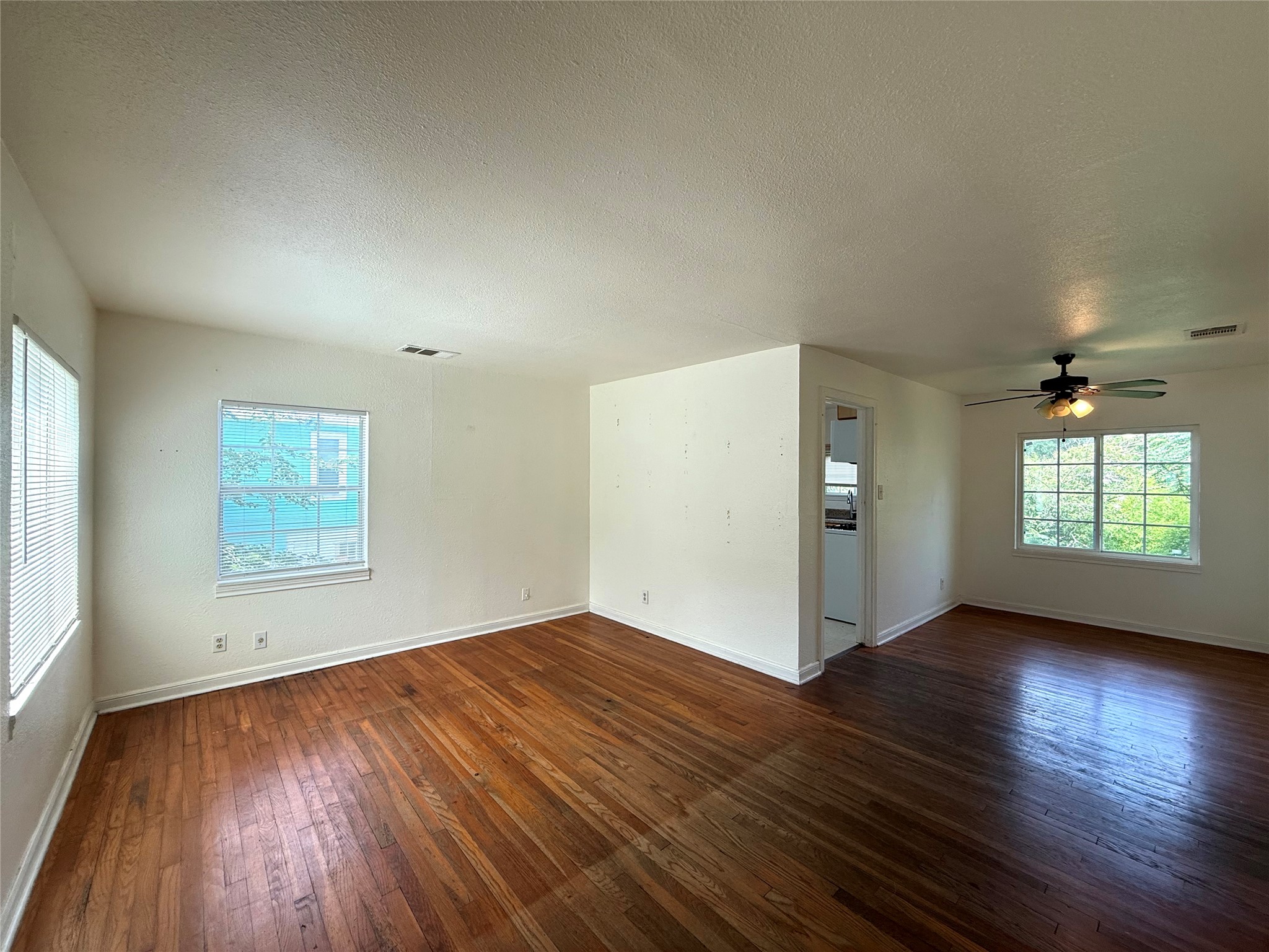 3305 Merrie Lynn Avenue Austin, TX 78722 - Photo 3 of 22 Sun-filled interiors feature rich hardwood flooring and ample window light.