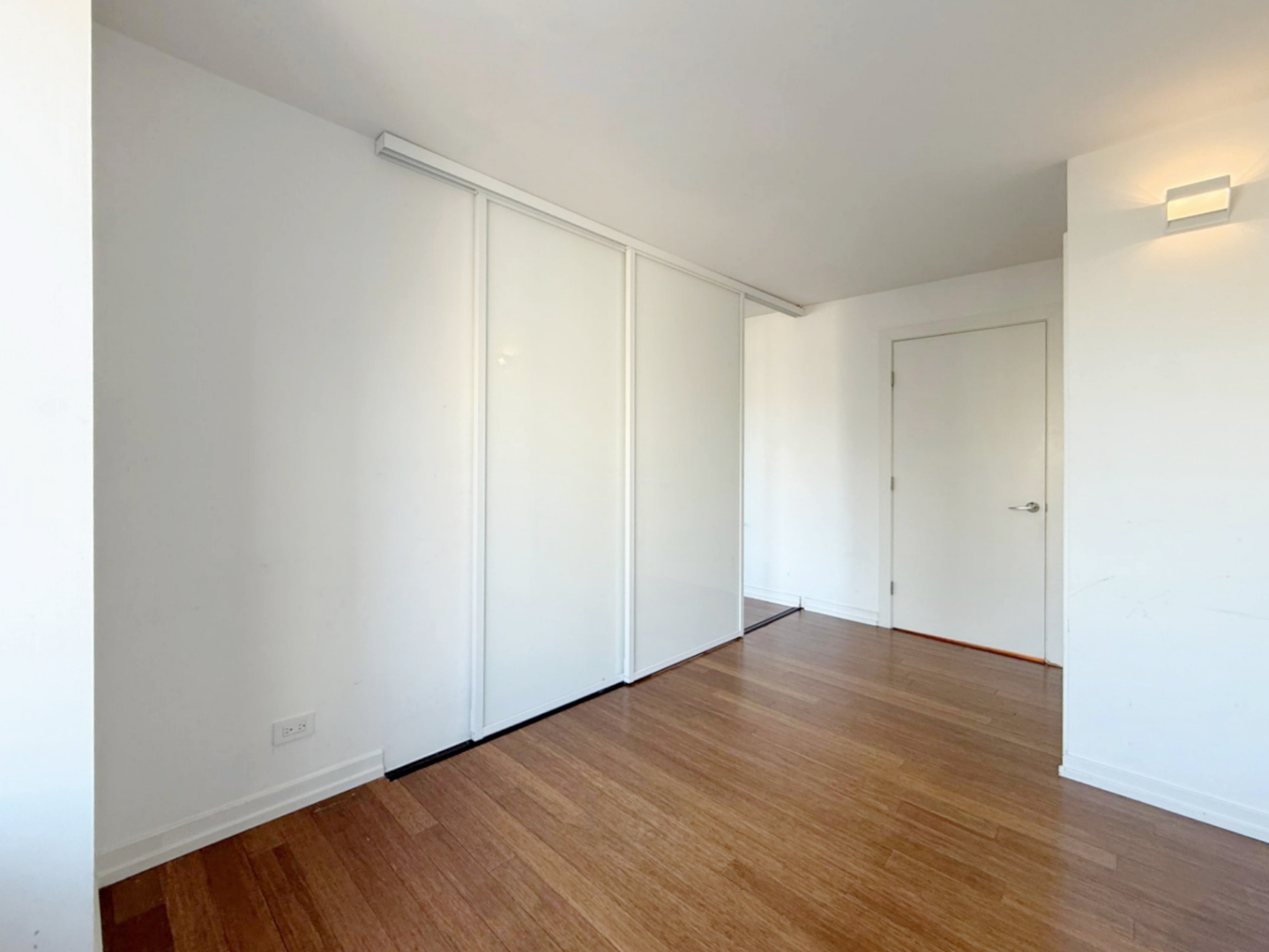 211 East Ohio Street, Unit 2707 Chicago, IL 60611 - Photo 17 of 43 a view of an empty room with wooden floor