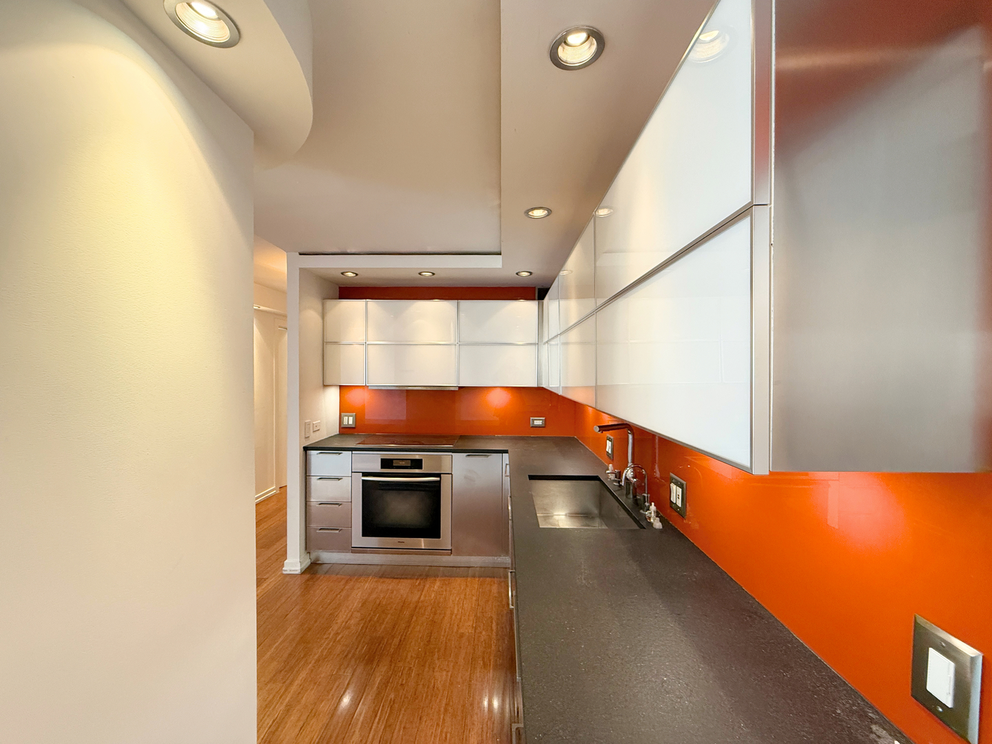 211 East Ohio Street, Unit 2707 Chicago, IL 60611 - Photo 3 of 43 a view of a kitchen with a sink and a fireplace