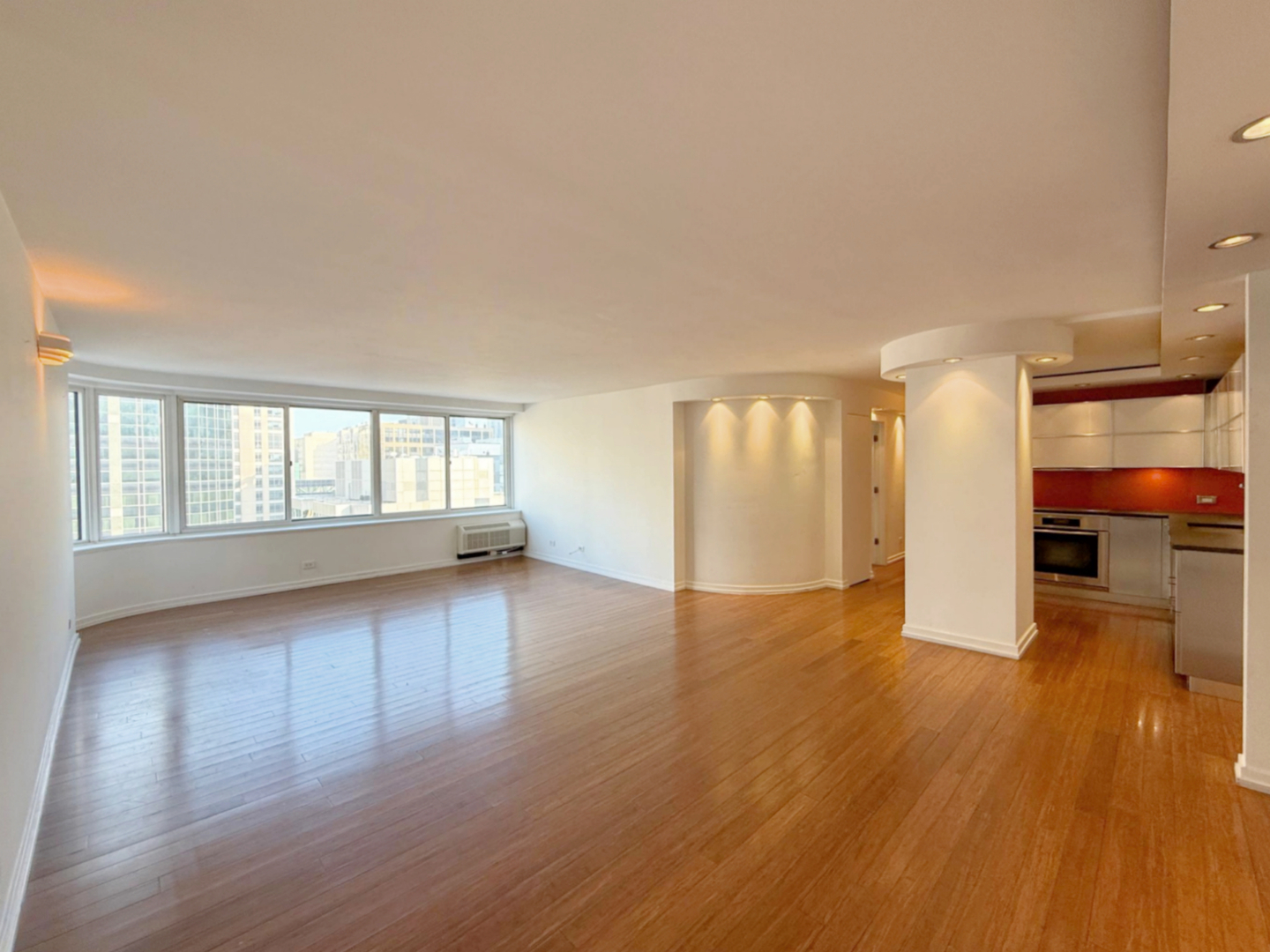 211 East Ohio Street, Unit 2707 Chicago, IL 60611 - Photo 7 of 43 an empty room with wooden floor and windows