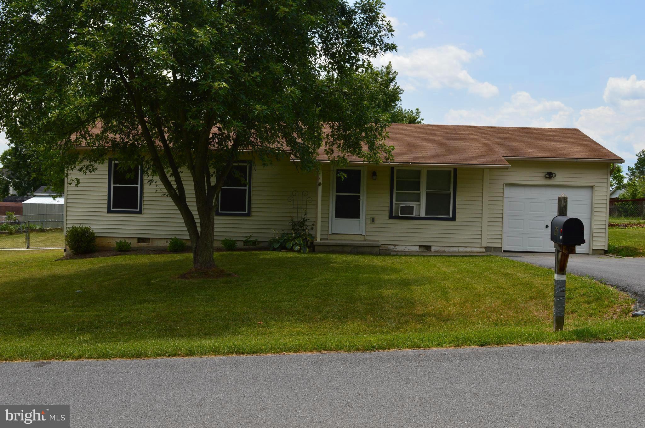 96 Harding Lane Inwood, WV 25428 - Photo 2 of 27 a front view of a house with a garden and plants