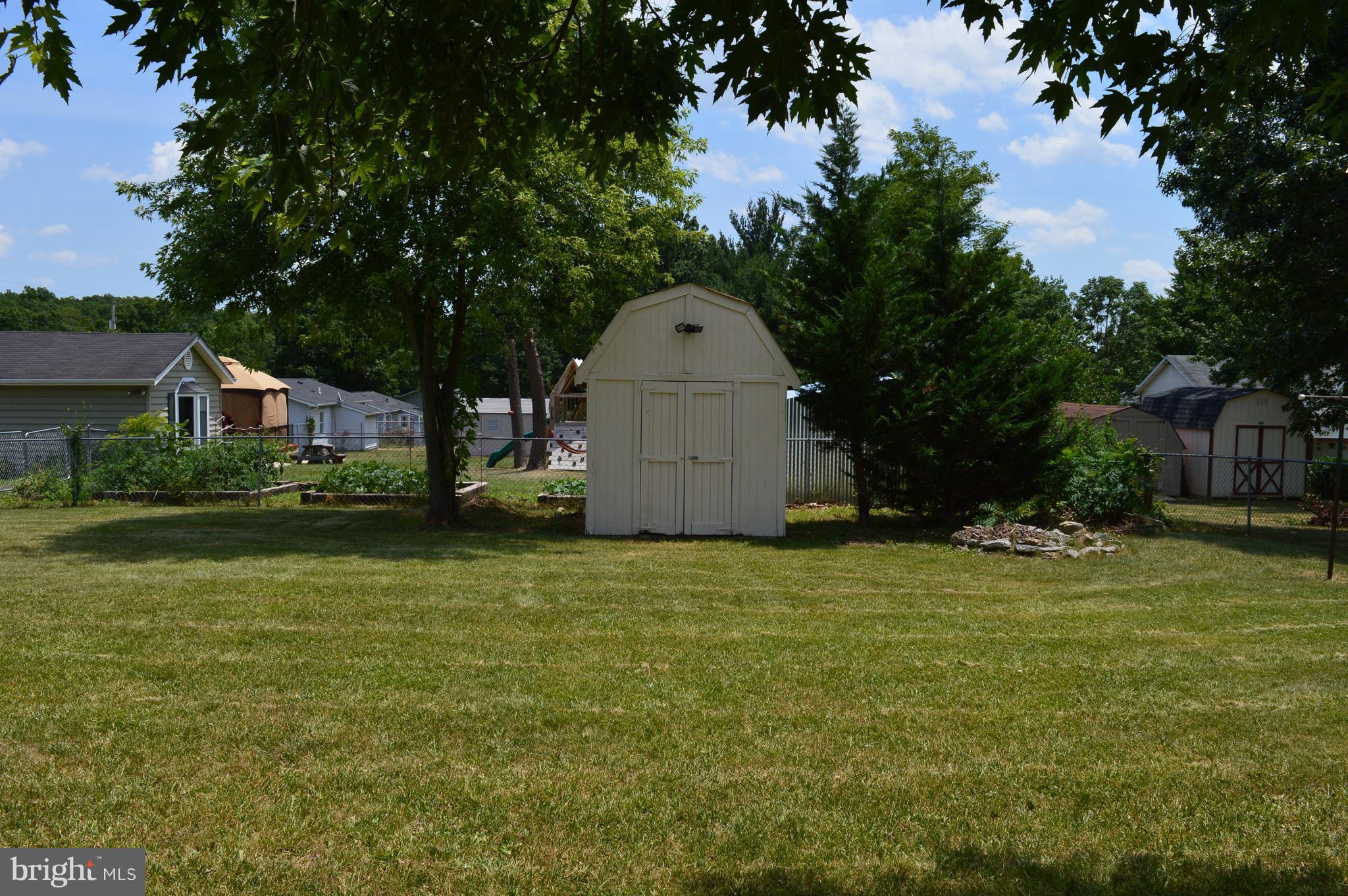 96 Harding Lane Inwood, WV 25428 - Photo 24 of 27 a front view of house with yard and trees