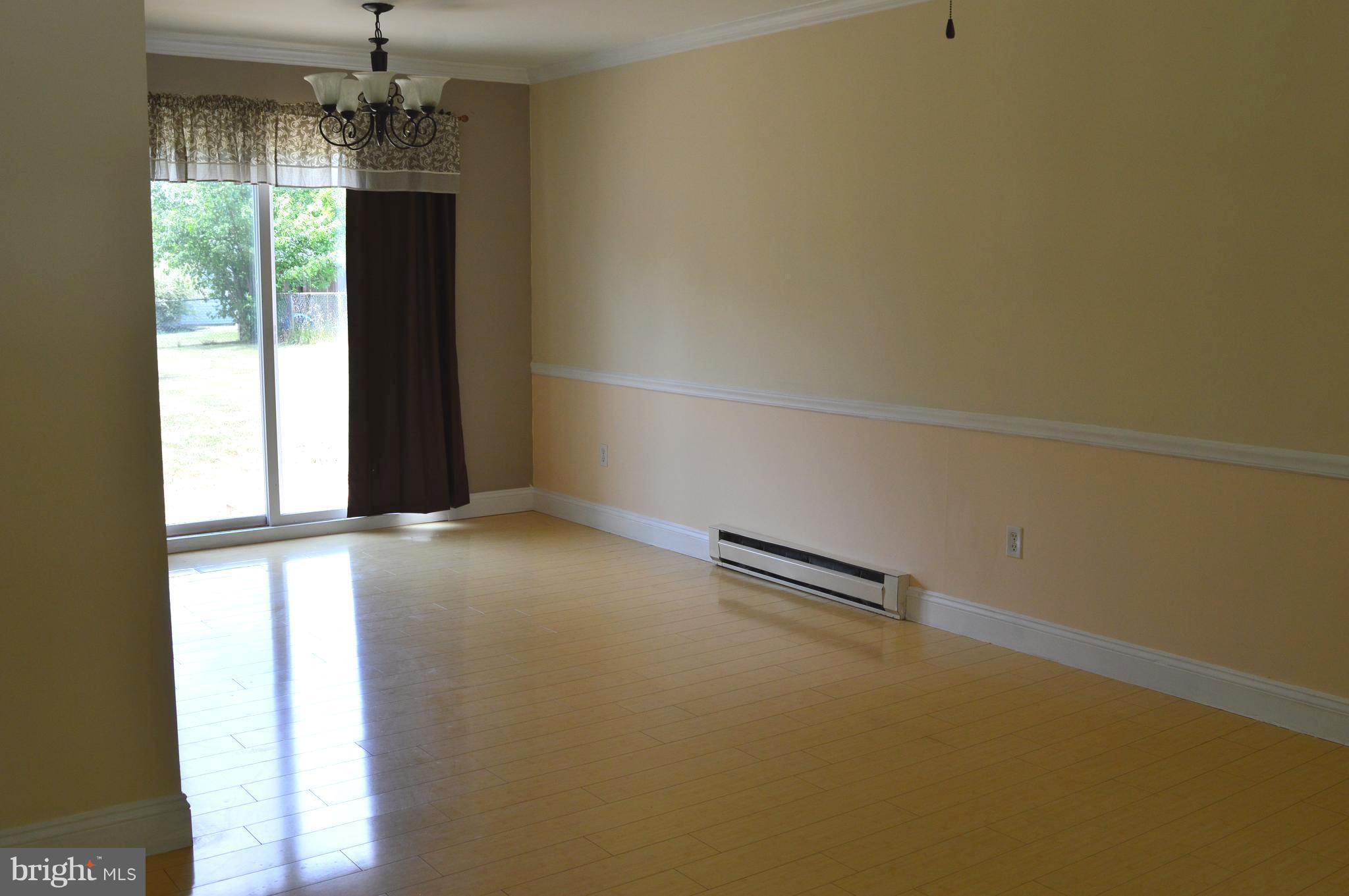 96 Harding Lane Inwood, WV 25428 - Photo 6 of 27 en empty room with windows and chandelier
