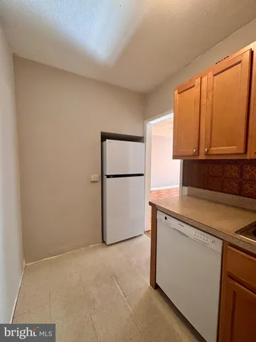 a kitchen with a refrigerator sink and cabinets