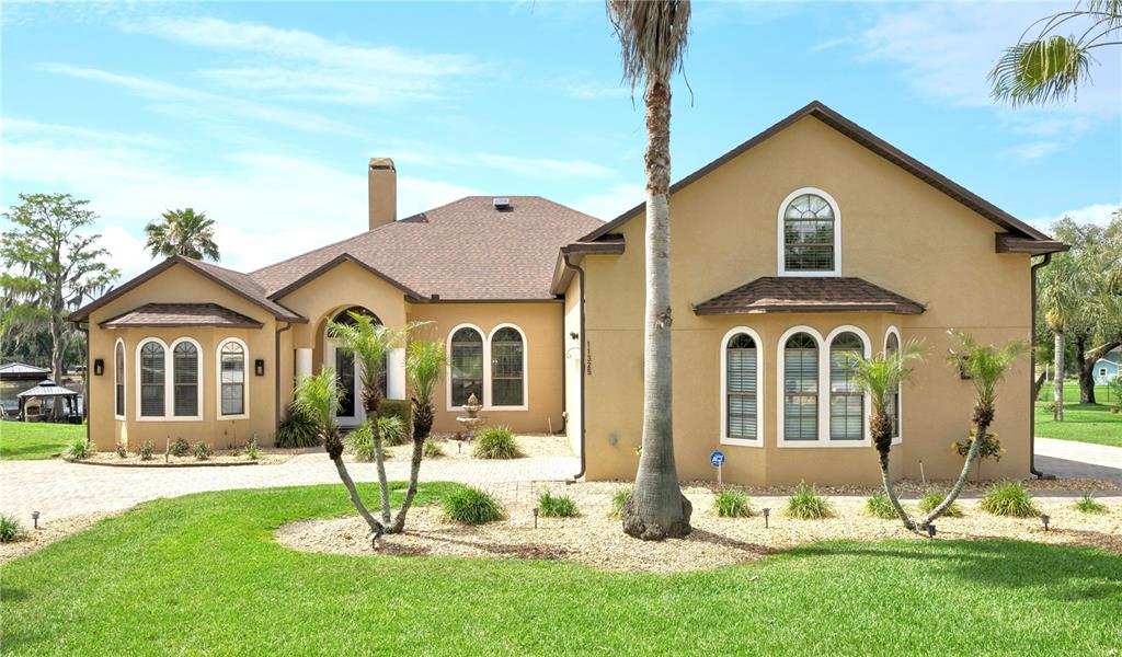 11325 Preston Cove Road Clermont, FL 34711 - Photo 6 of 58 a front view of a house with a yard