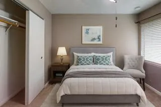 a bedroom with a bed and a window