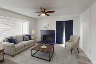 a living room with furniture and a fireplace