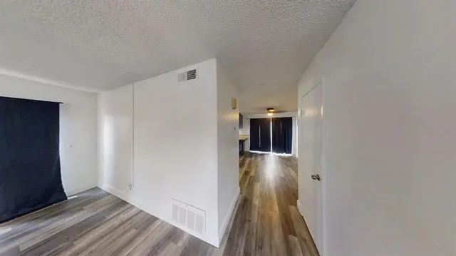a view of hallway with wooden floor