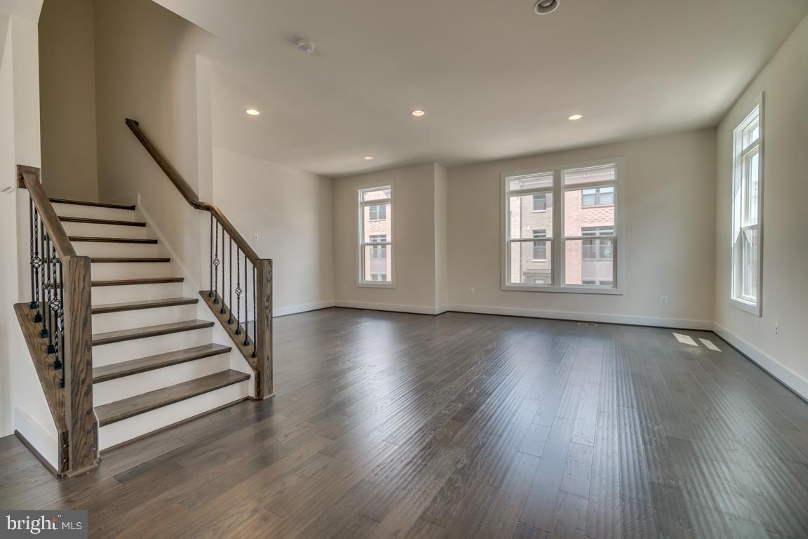 44721 Ellsworth Terrace Ashburn, VA 20147 - Photo 14 of 51 a view of an empty room with wooden floor and fan