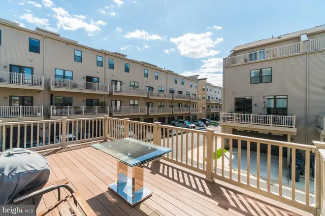 a roof deck with wooden floor and fence