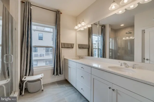 a bathroom with a granite countertop sink mirror and double