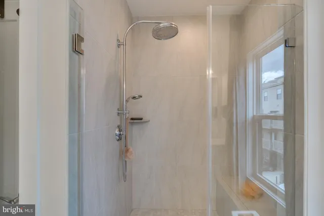 a bathroom with a glass shower door