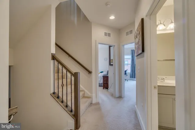 a view of a hallway with windows and stairs