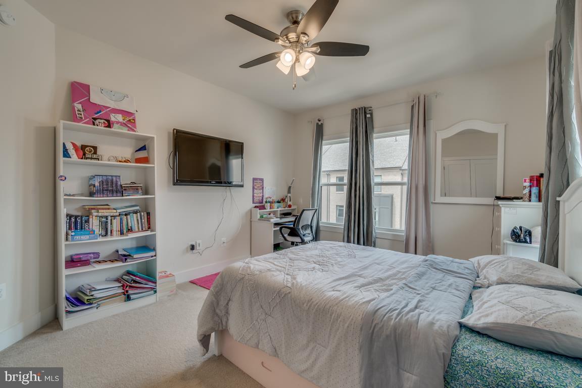 44721 Ellsworth Terrace Ashburn, VA 20147 - Photo 25 of 51 a bedroom with a bed and a flat screen tv