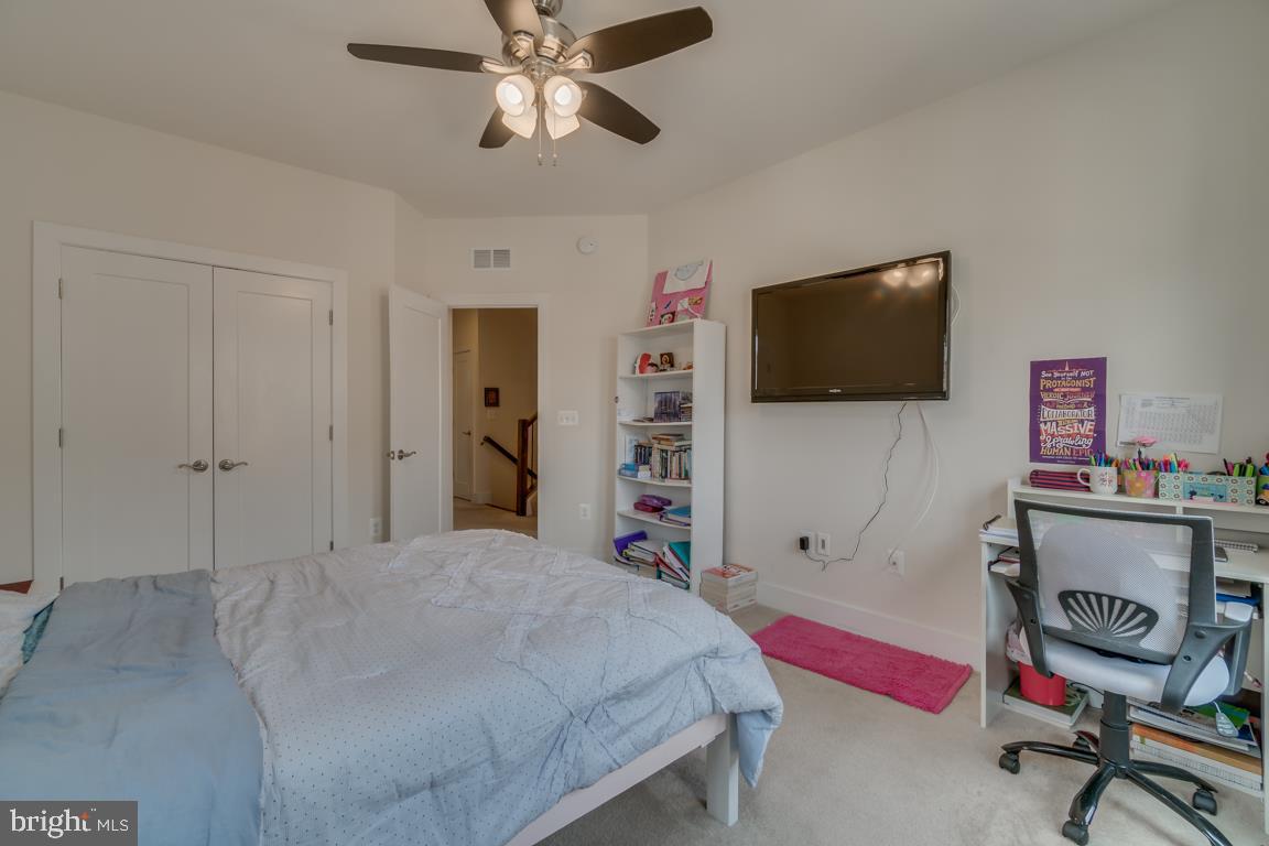 44721 Ellsworth Terrace Ashburn, VA 20147 - Photo 26 of 51 a bedroom with a bed and a flat screen tv