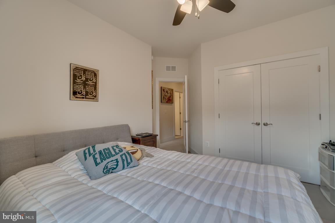 44721 Ellsworth Terrace Ashburn, VA 20147 - Photo 29 of 51 a bedroom with a bed and a chandelier