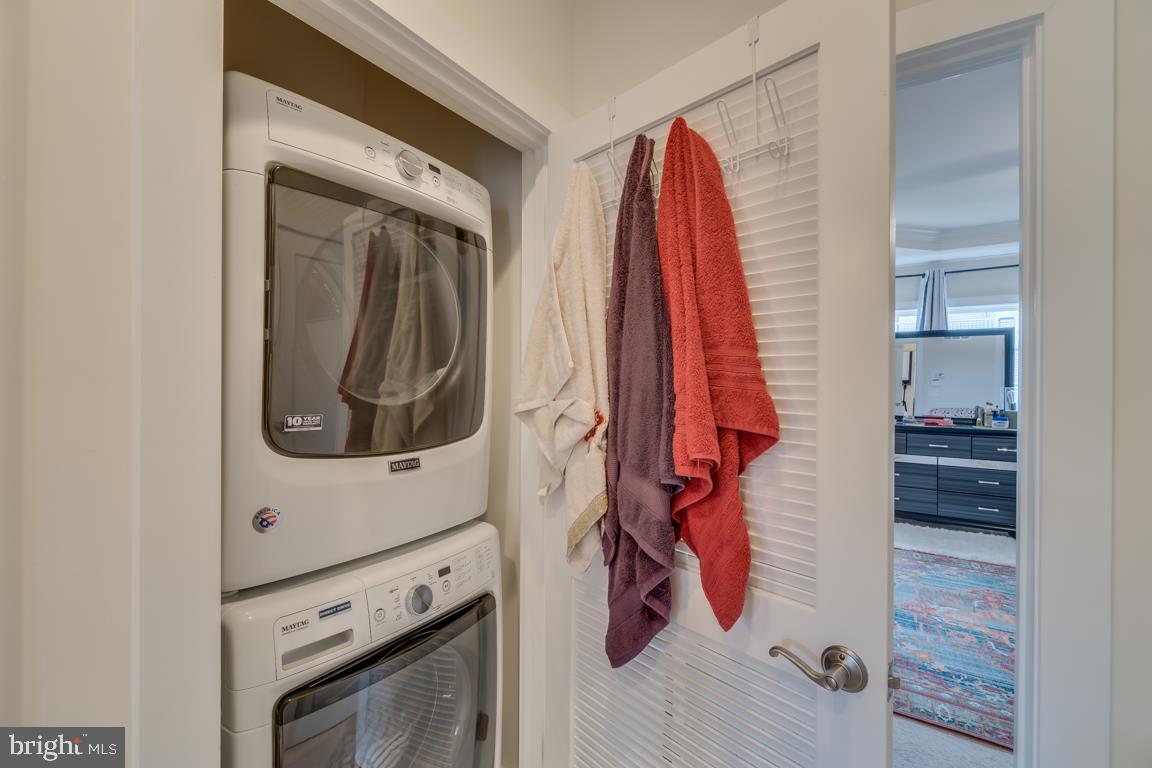 44721 Ellsworth Terrace Ashburn, VA 20147 - Photo 31 of 51 a view of walk in closet with clothes and shoes