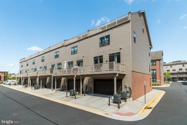 a front view of a house with sitting area and garden