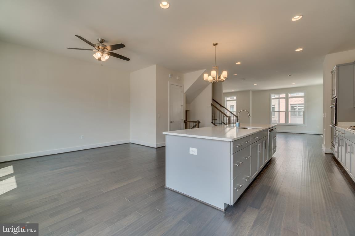 44721 Ellsworth Terrace Ashburn, VA 20147 - Photo 10 of 51 a living room with couches and kitchen view with wooden floor