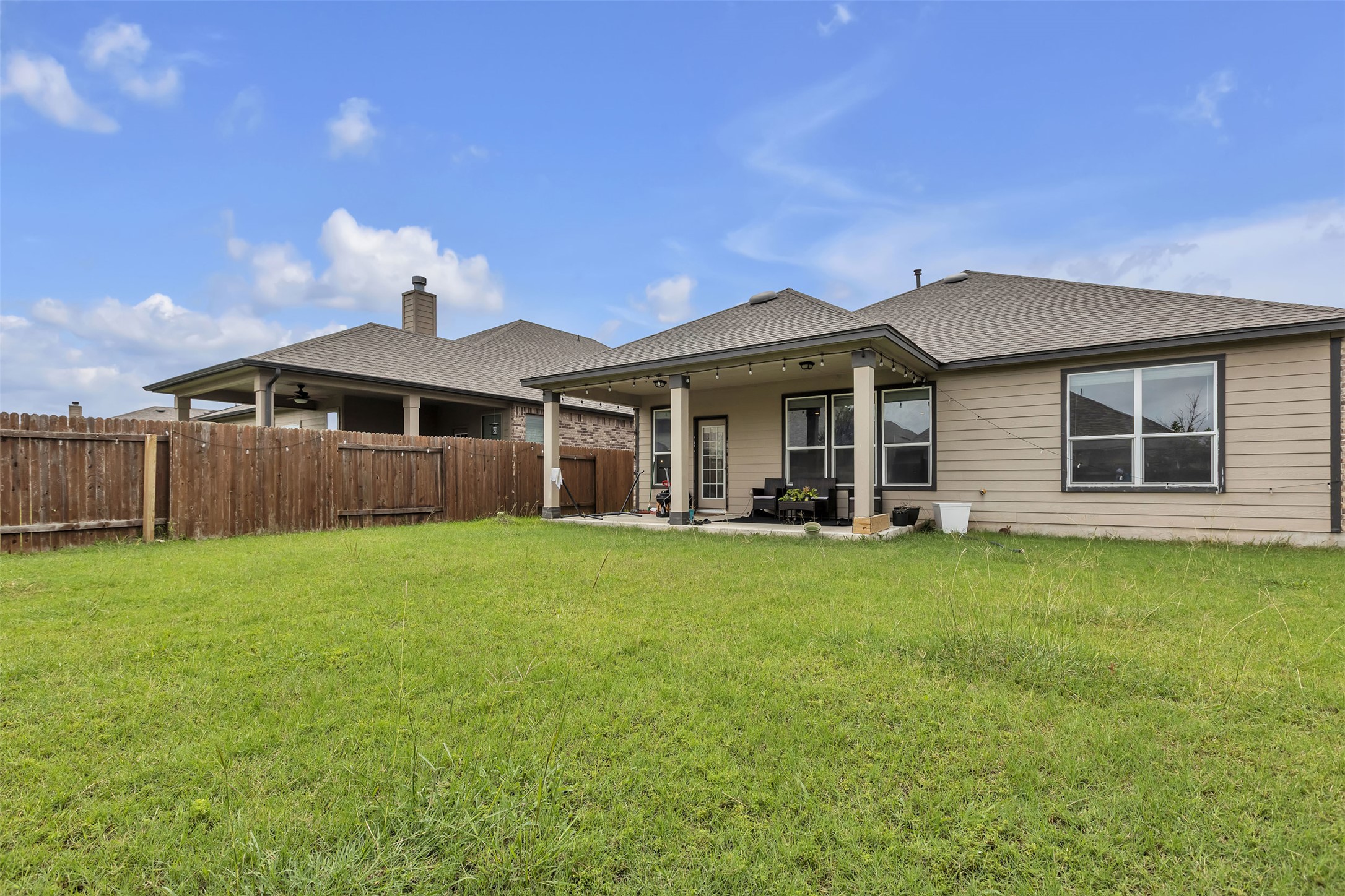 128 Kavanaugh Street Georgetown, TX 78628 - Photo 13 of 13 Spacious backyard featuring a covered patio, privacy fencing, and ample green space