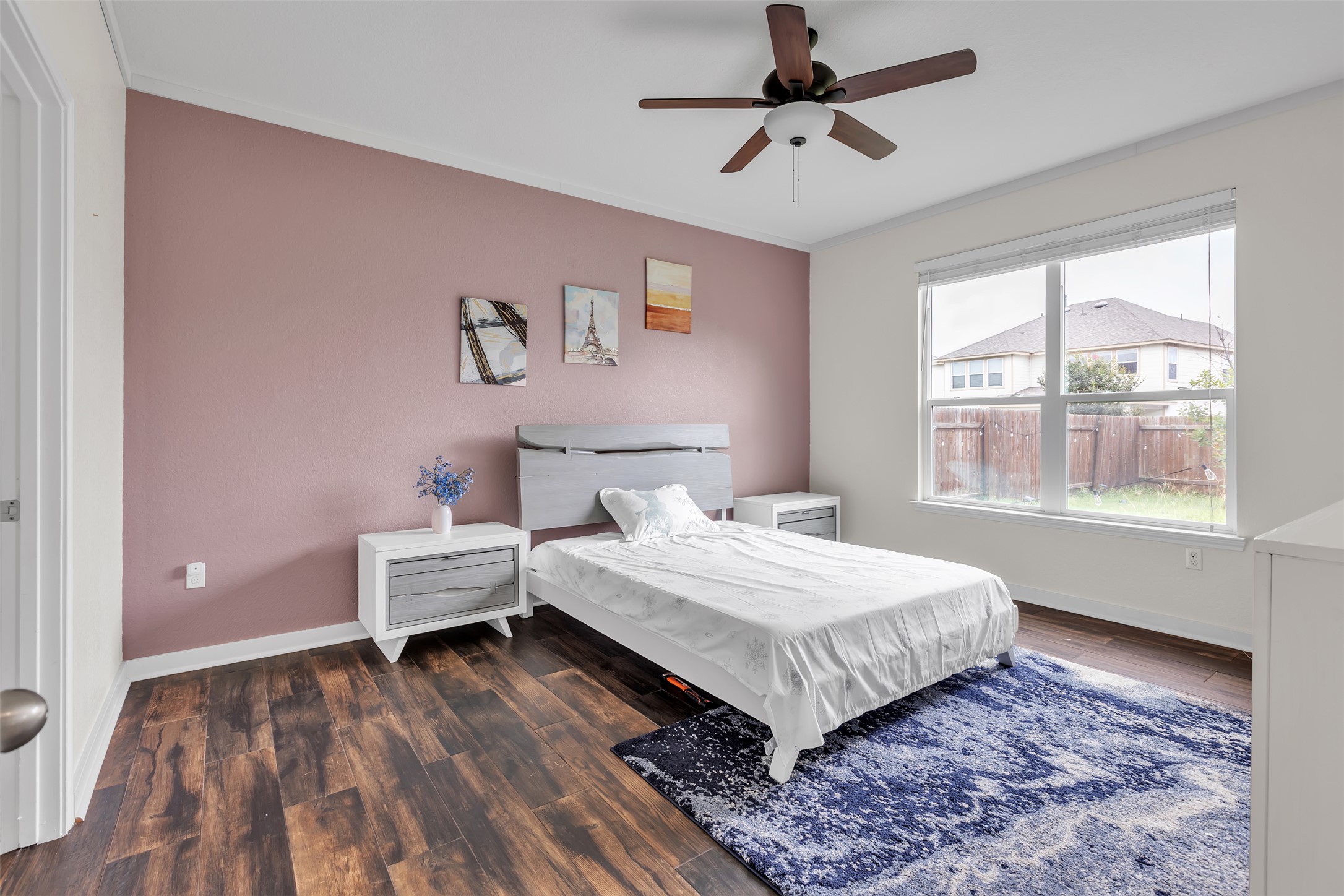 128 Kavanaugh Street Georgetown, TX 78628 - Photo 9 of 13 Bedroom featuring wood-finish flooring, a ceiling fan with integrated lighting, and a large window