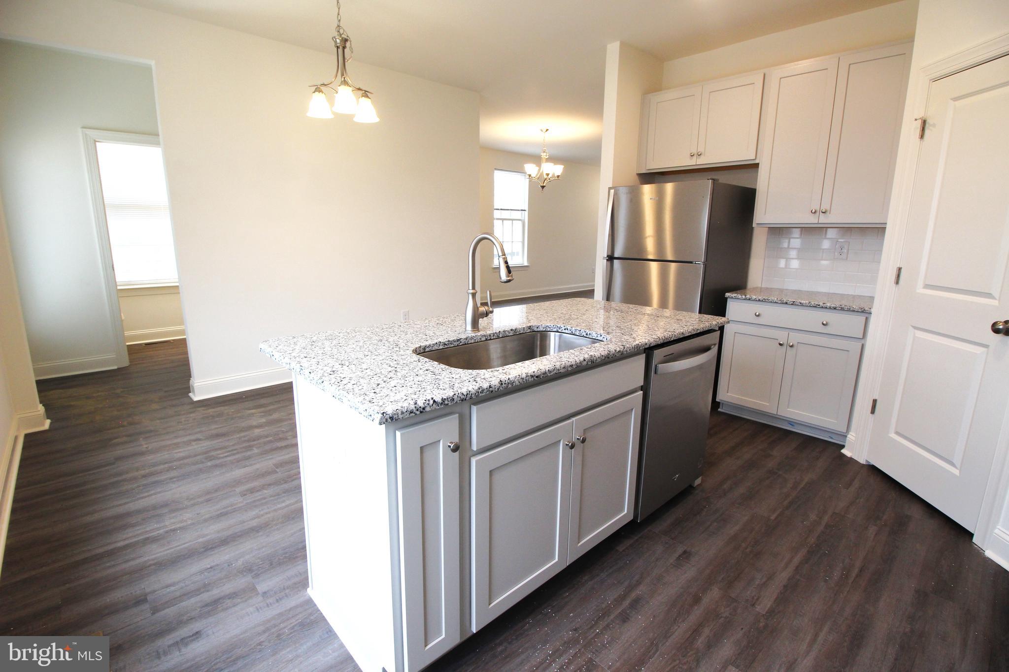 851 Mapleton Avenue Middletown, DE 19709 - Photo 12 of 26 a kitchen with stainless steel appliances granite countertop a sink dishwasher a refrigerator and a stove with wooden floor
