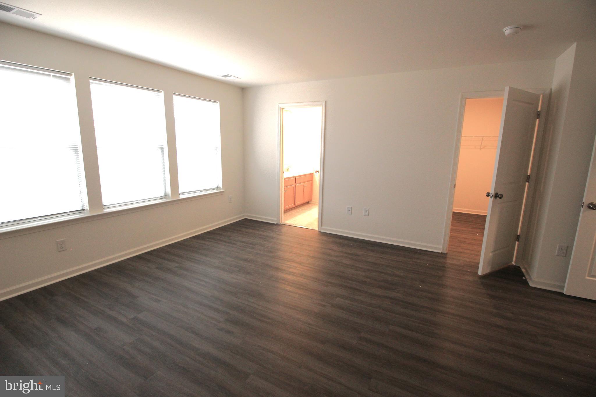 851 Mapleton Avenue Middletown, DE 19709 - Photo 16 of 25 an empty room with wooden floor and windows