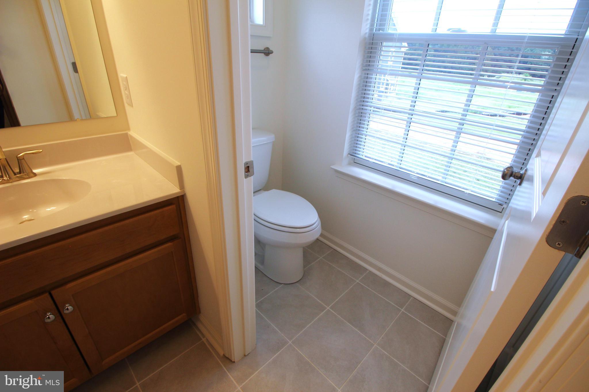 851 Mapleton Avenue Middletown, DE 19709 - Photo 20 of 25 a bathroom with a sink toilet and window