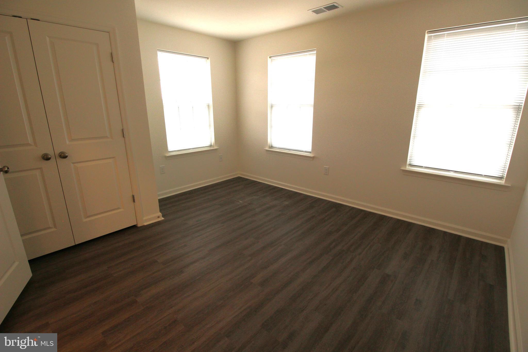851 Mapleton Avenue Middletown, DE 19709 - Photo 22 of 25 a view of an empty room with wooden floor and a window