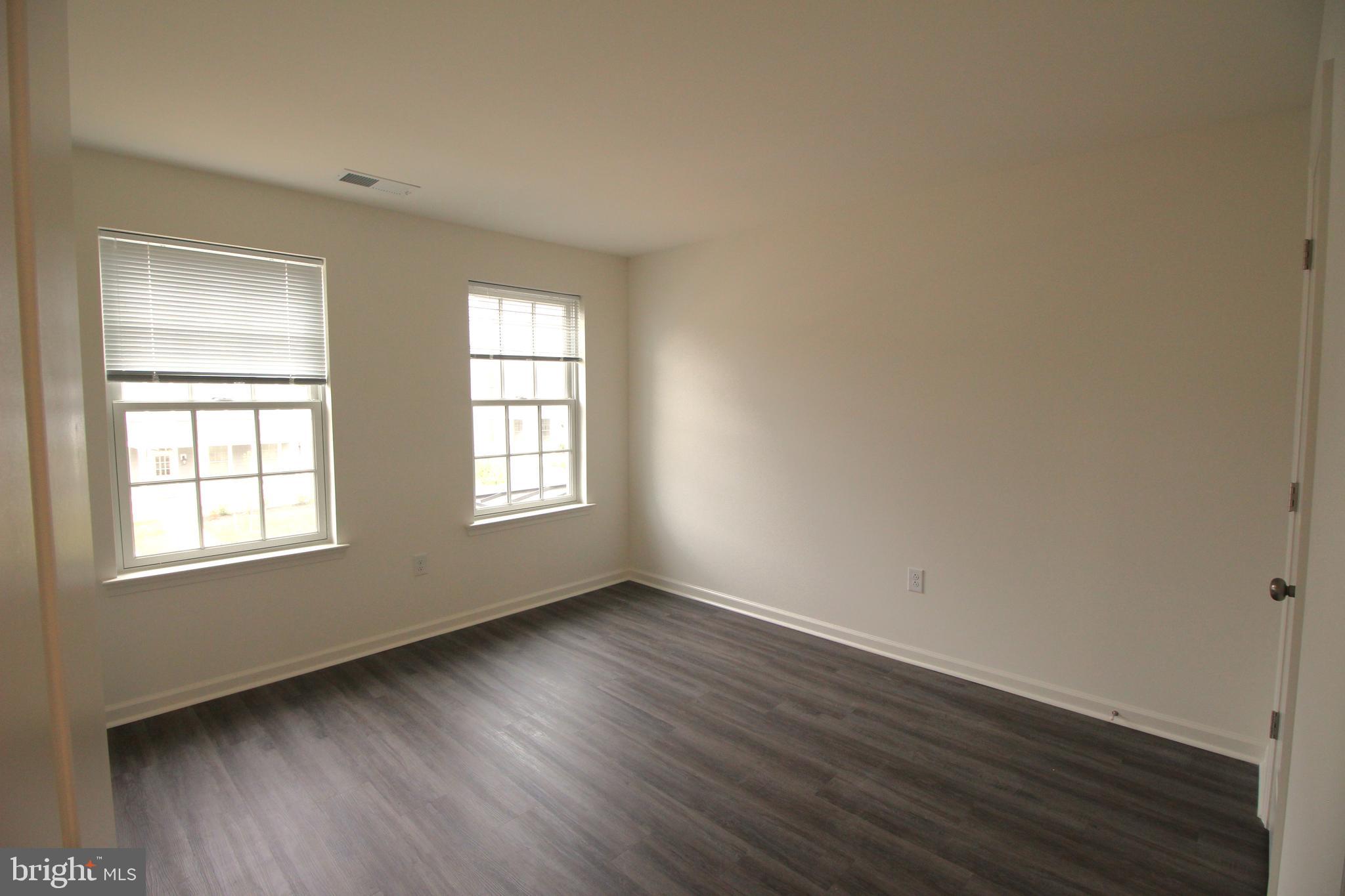 851 Mapleton Avenue Middletown, DE 19709 - Photo 22 of 26 an empty room with wooden floor and windows