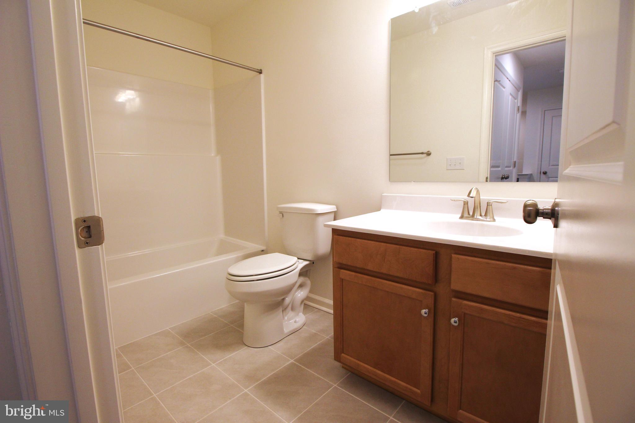 851 Mapleton Avenue Middletown, DE 19709 - Photo 23 of 25 a bathroom with a sink a toilet and shower