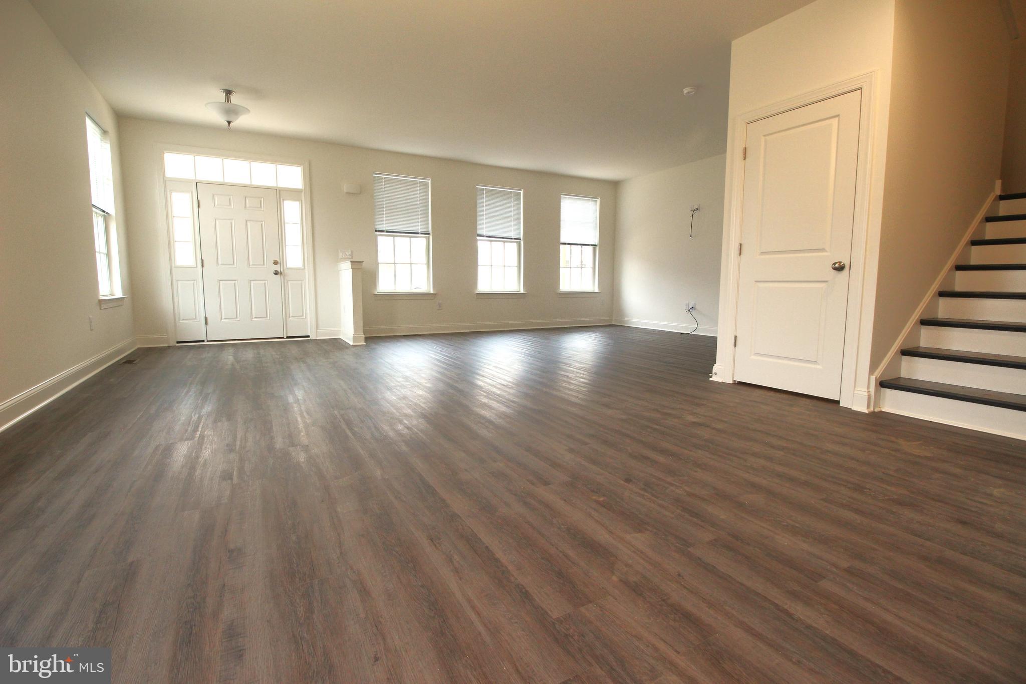 851 Mapleton Avenue Middletown, DE 19709 - Photo 5 of 25 an empty room with wooden floor and windows