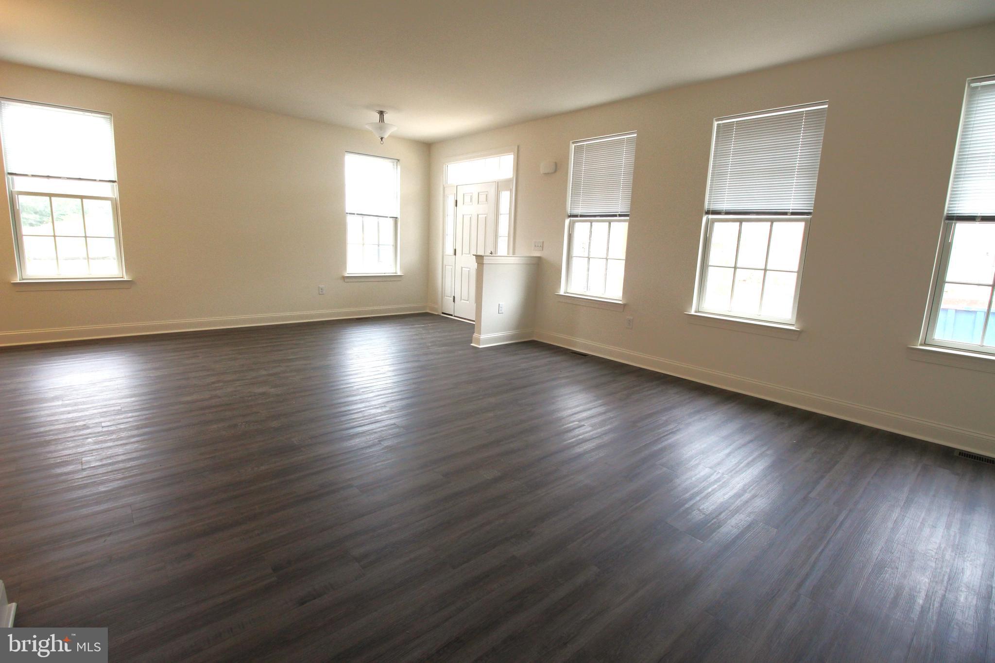 851 Mapleton Avenue Middletown, DE 19709 - Photo 7 of 26 a view of an empty room with wooden floor and window