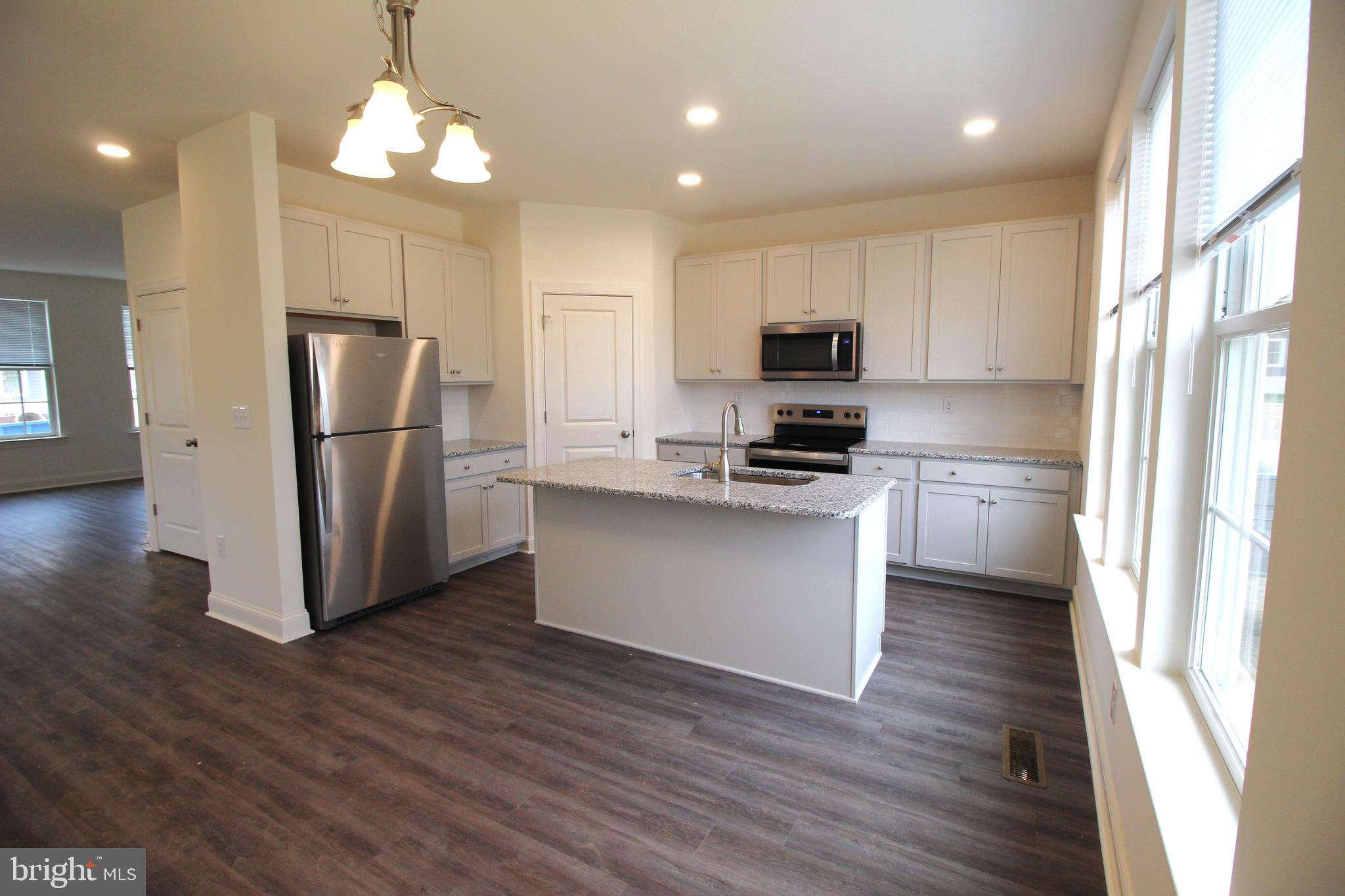 851 Mapleton Avenue Middletown, DE 19709 - Photo 9 of 25 a kitchen with stainless steel appliances a refrigerator and a stove top oven