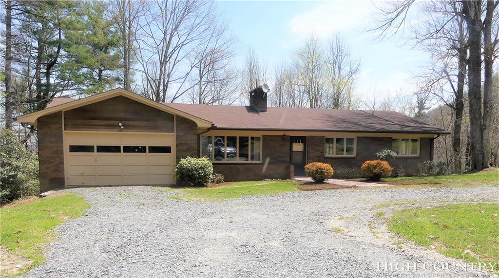 567 Deck Hill Road Boone, NC 28607 - Photo 1 of 25 a front view of a house with yard and porch